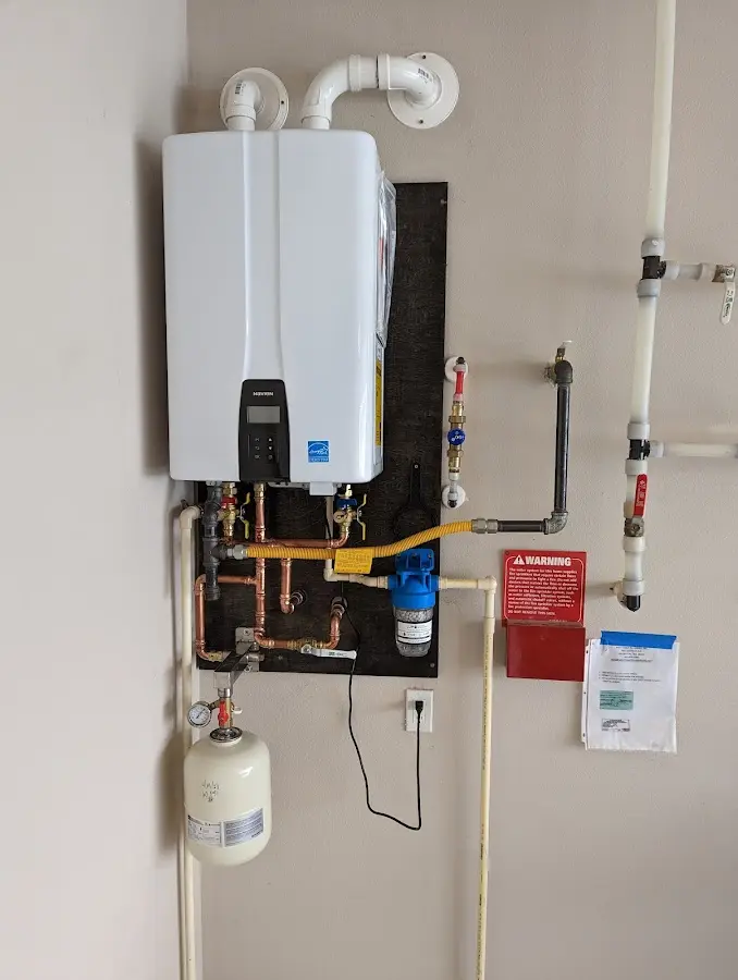 Professional plumber installing copper piping in a Quincy home